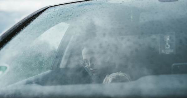 A lady on the cars passenger side wearing a seat belt