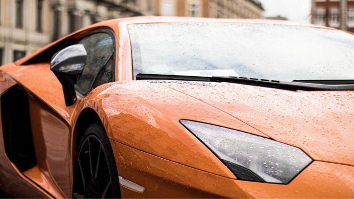 An orange color body painted car